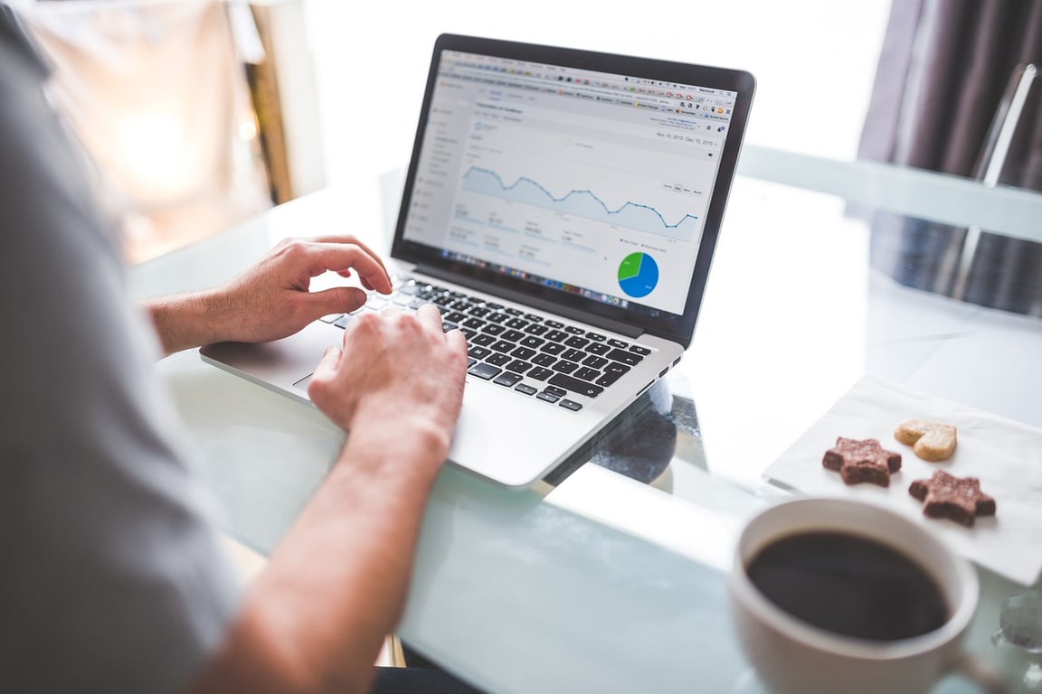 A professional reviewing hotel website performance data to boost online visibility and bookings.