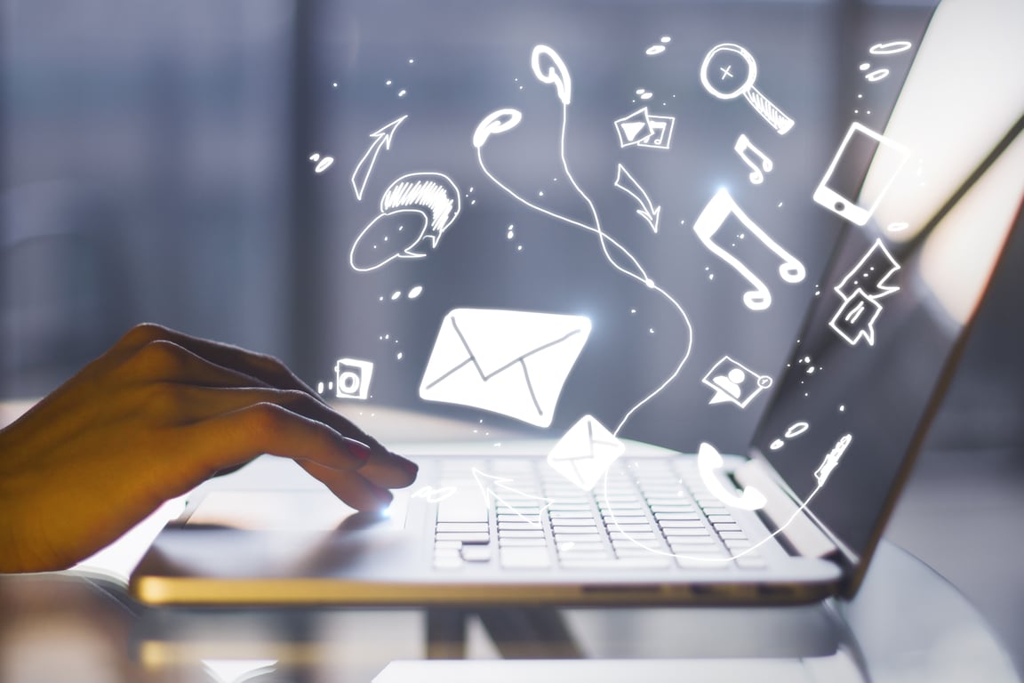 A hand typing on a laptop with icons symbolizing email marketing and guest engagement