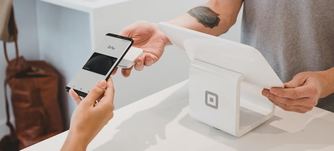 Hotel guest paying through a smartphone