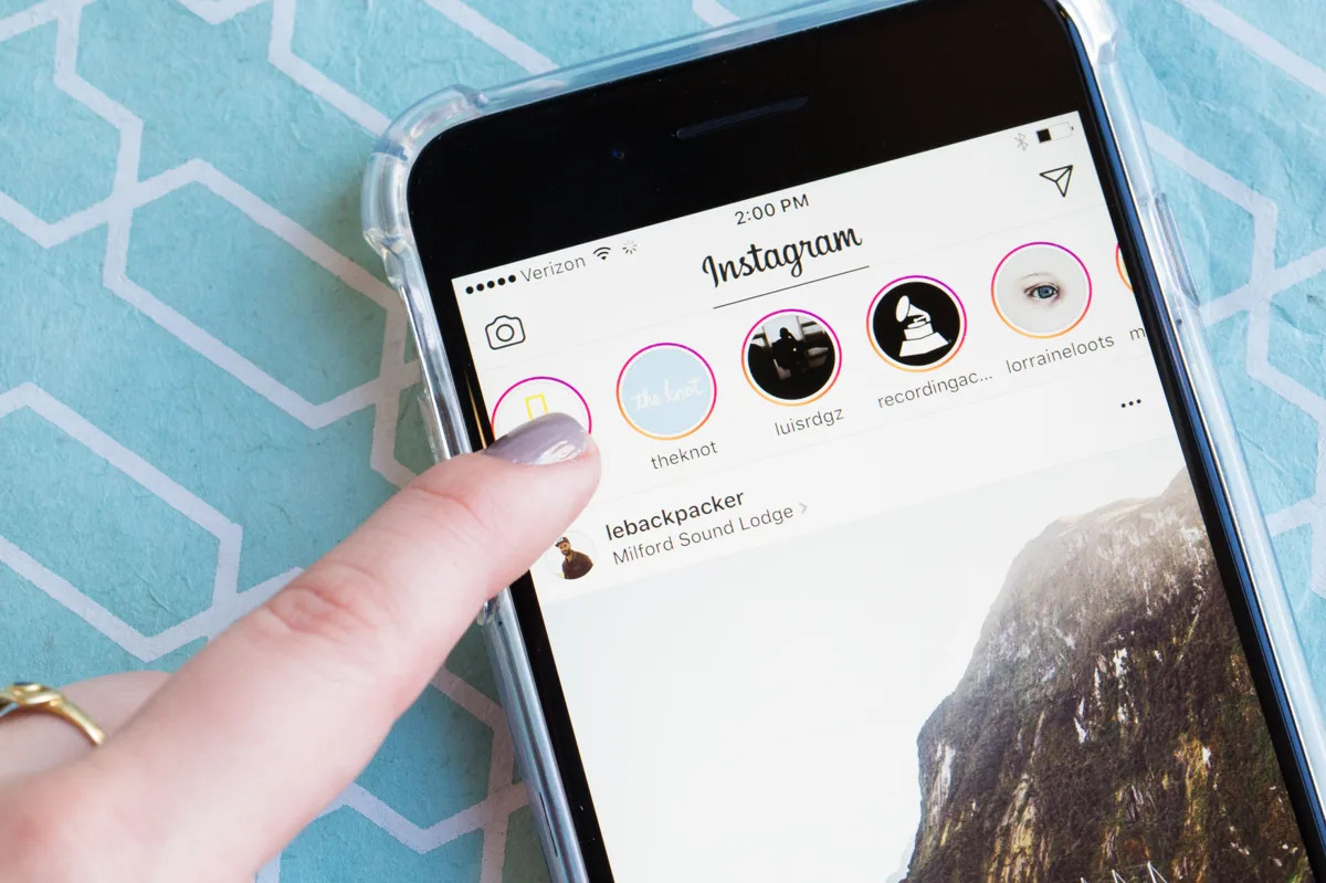 Person showing Instagram stories on a smartphone.